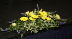 The large floral arrangement on the top table.